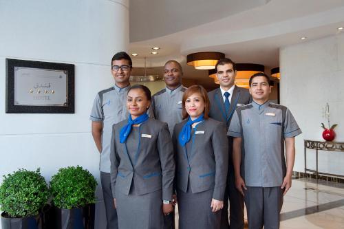 a group of people posing for a picture in a room at City Seasons Towers Hotel Bur Dubai in Dubai