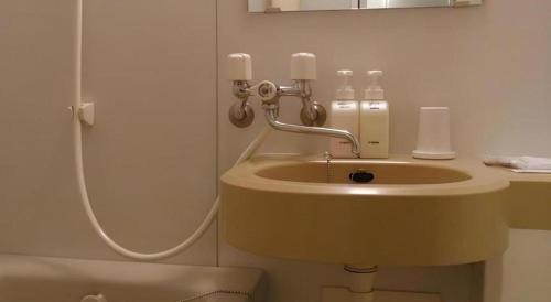 a bathroom with a sink and a shower at Chino Station Hotel in Chino