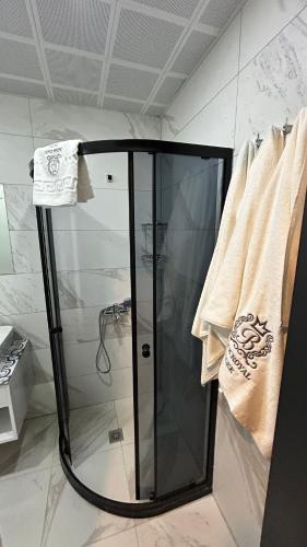a shower with a glass door in a bathroom at Black Royal Belek in Belek
