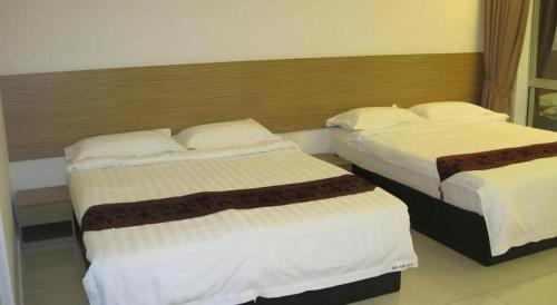 a hotel room with two beds in a room at One Home Hotel in Batang Kali