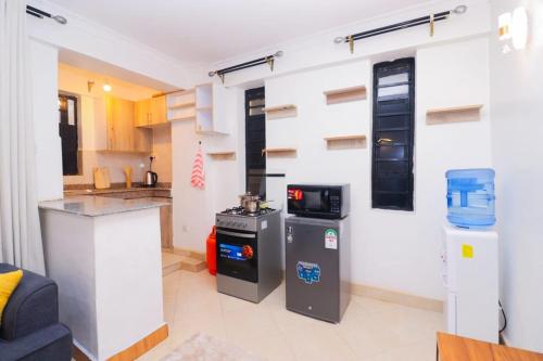 a kitchen with a stove and a counter in a room at Crown Z Tower in Ruiru