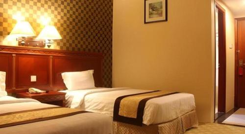 a hotel room with two beds in a room at MB Hotel in Tawau