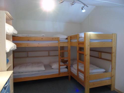 une chambre avec deux lits superposés dans une pièce dans l'établissement Charmant 2P Mezzanine à 20m des Remontées, Balcon Sud, Casier à Ski, Draps Inclus, Valfréjus - FR-1-561-16, à Modane