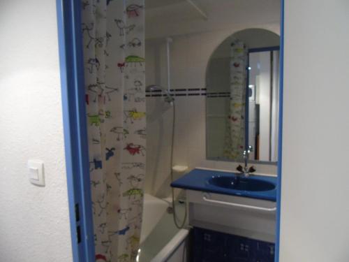 une salle de bain avec un lavabo et un rideau de douche avec des poissons dessus dans l'établissement Charmant 2P Mezzanine à 20m des Remontées, Balcon Sud, Casier à Ski, Draps Inclus, Valfréjus - FR-1-561-16, à Modane