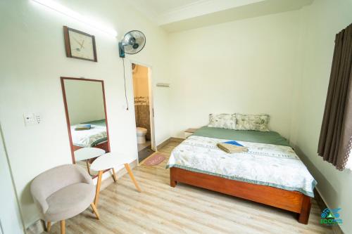 a small bedroom with a bed and a mirror at Cao Bang Eco Homestay in Cao Bằng