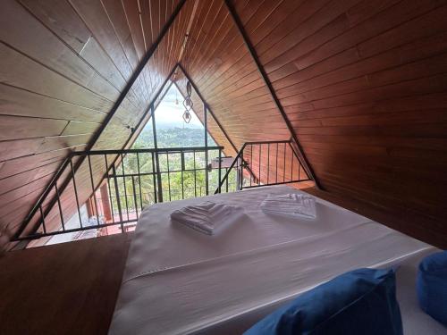 a large bed in a room with a large window at Kandy Twin Villa in Kandy