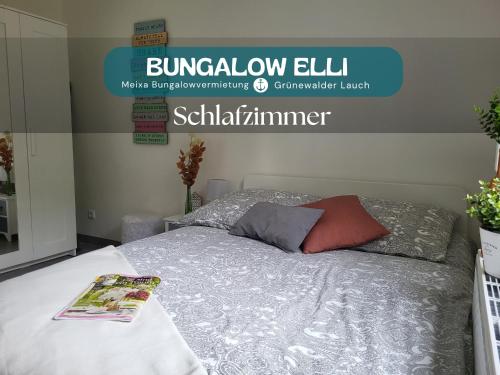 a bedroom with a bed with a book on it at Bungalow Grünewalder Lauch in Lauchhammer