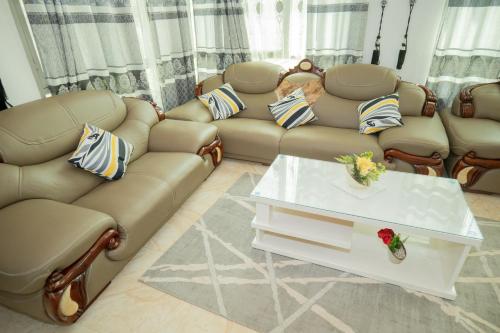 a living room with a couch and a table at The city Block Apartment in Bujumbura
