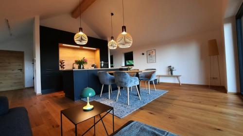 a living room with a table and chairs in it at raum14 in Böbrach