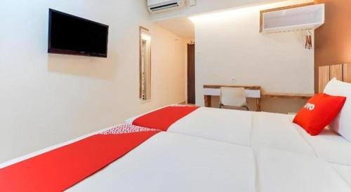 Postel nebo postele na pokoji v ubytování GM Holiday Hotel Permai Jaya