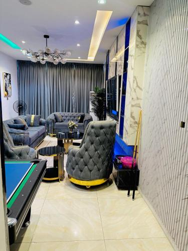 a living room with a ping pong table and a pool table at 4 Bedroom Self compound Duplex with pool and bq in Ikate Lekki in Lekki