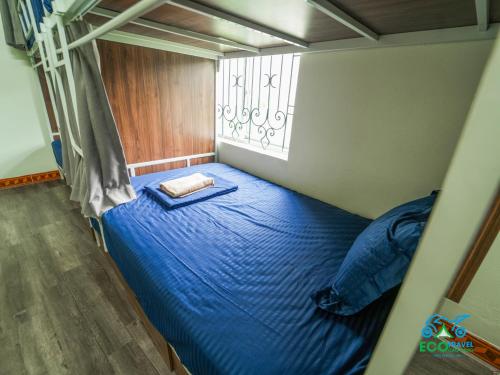a bed in a room with a blue bed at Cao Bang Eco Homestay in Cao Bằng