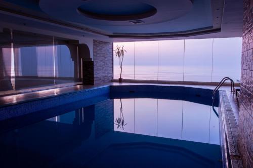 a swimming pool in a house with a view at Sumou Hotel Al Khobar in Al Khobar