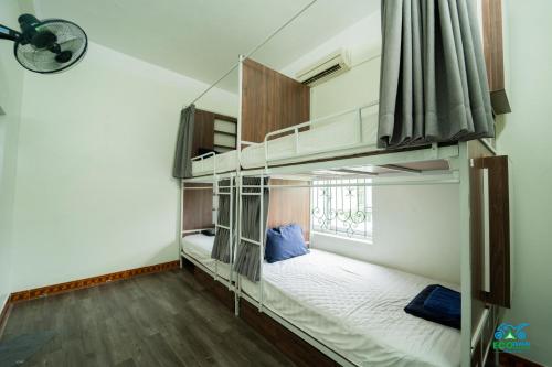 a room with two bunk beds and a window at Cao Bang Eco Homestay in Cao Bằng