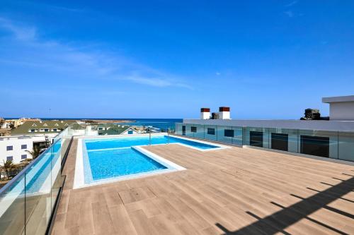 a view of a swimming pool on the roof of a building at Apartamentos Golfinho Dourado in Santa Maria