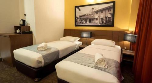 Postel nebo postele na pokoji v ubytování Hotel Scholar's Suites