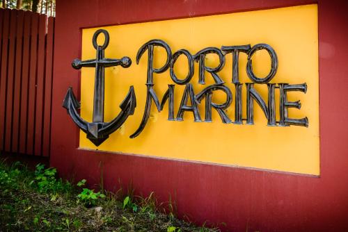 a sign on a wall with an anchor on it at Porto Marine in Jūrmala