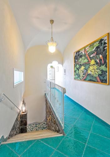 a staircase with blue tile floors and a painting on the wall at Villa dei Lecci - 7 Luxury villas with private pool or jacuzzi in Ischia