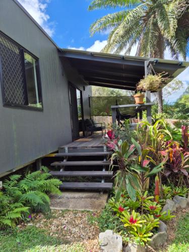 a house with stairs leading to a porch with a patio at Greenhills Retreat in Kuranda