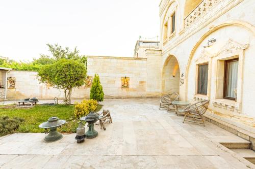 a courtyard of a building with tables and chairs at Walnut House in Goreme
