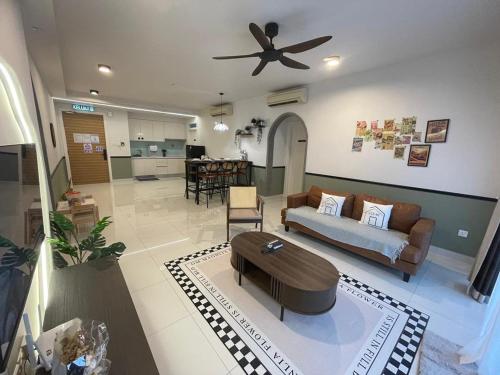 a living room with a couch and a ceiling fan at Teega Residence B L2 near Legoland by UCoMeStay in Iskandar Puteri