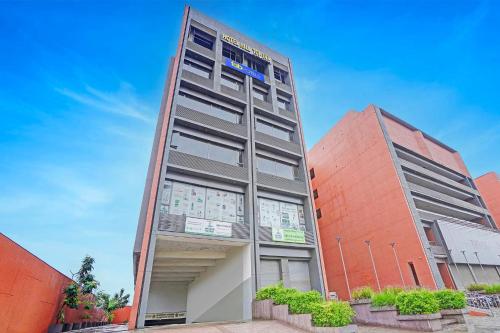 a building with a sign on the side of it at FabHotel Hill Top Inn in Ahmedabad