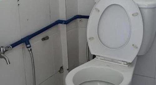a bathroom with a toilet with the lid up at OYO 90785 Pandan Hotel in Kota Kinabalu