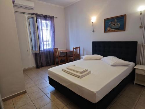 a bedroom with a bed with two towels on it at Hera Hotel in Nafplio