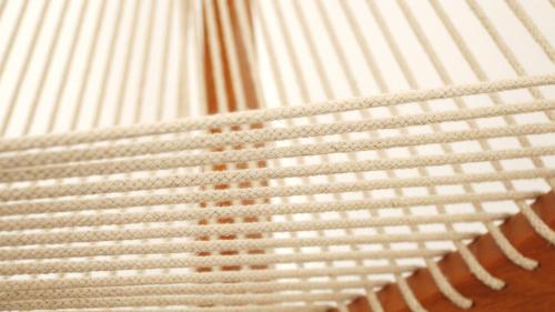 a close up of a bed with white sheets at Cavo Bianco Boutique Hotel & Spa in Kamari