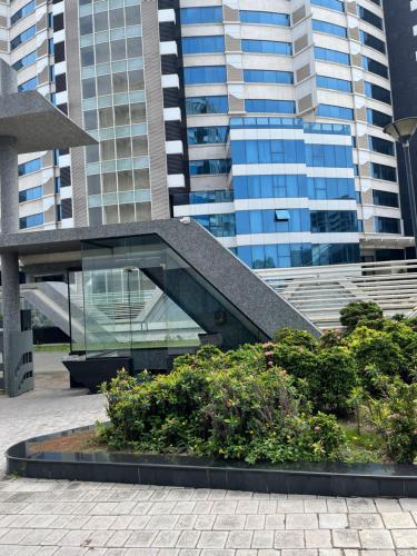 a sculpture in front of a building with tall buildings at belliza apartment in Surat