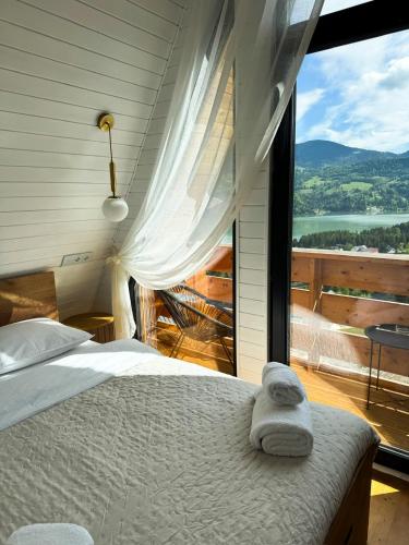 a bedroom with a bed and a large window at A Frame Girasole in Colibiţa