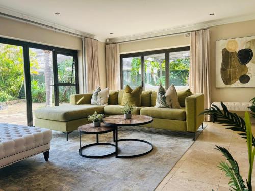 a living room with a couch and a table at 2 On Lismore Guesthouse in Tokai