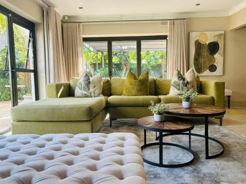 a living room with a couch and tables at 2 On Lismore Guesthouse in Tokai