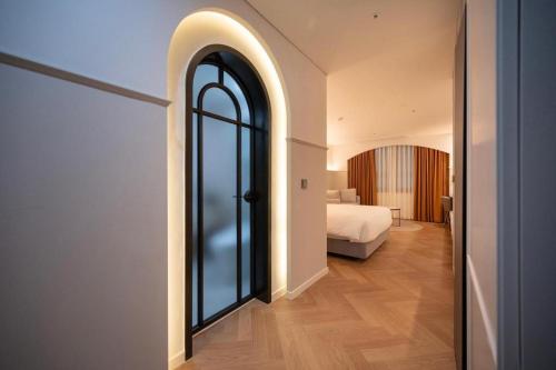 a bedroom with a bed and a large window at HOTEL D EDITION in Daejeon