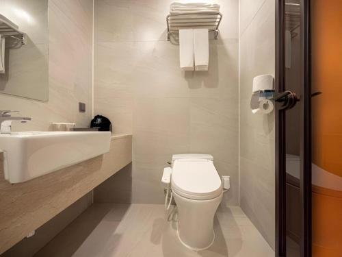 a bathroom with a white toilet and a sink at HOTEL D EDITION in Daejeon