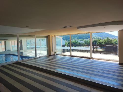 a large empty room with a view of a mountain at MARINA SOL VIVEIRO in Viveiro