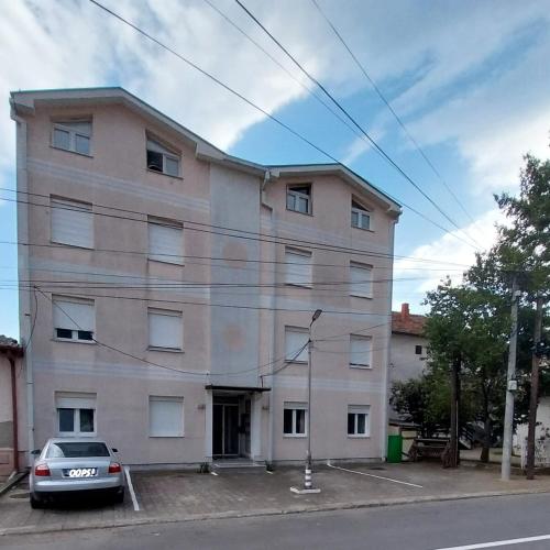 a building with a car parked in front of it at Sorin Apartments Gevgelija in Gevgelija
