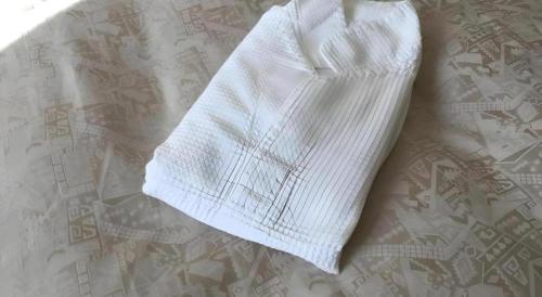 a white towel laying on top of a bed at Hotel Gran View Okinawa in Naha