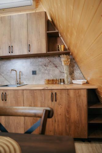 a kitchen with a sink and wooden cabinets at Drakhtiq Resort in Goris