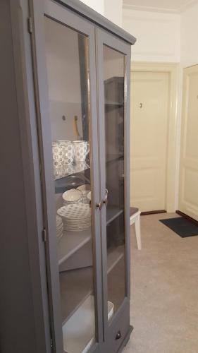 a glass cabinet with plates and dishes in it at City Lodge Stay A while in Zwolle