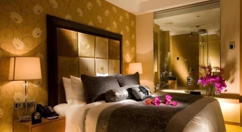 a bedroom with a large bed and a large mirror at Radegast Hotel CBD in Beijing