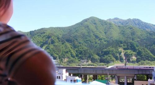 a person looking out of a window at a train at Yuzawa New Otani in Yuzawa