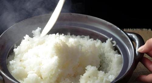 a bowl of white rice with a spoon in it at Yuzawa New Otani in Yuzawa