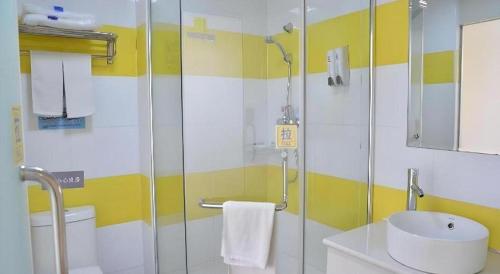 a bathroom with a shower and a sink and a toilet at 7 Days Inn Yiyang Shengli Road in Shangrao