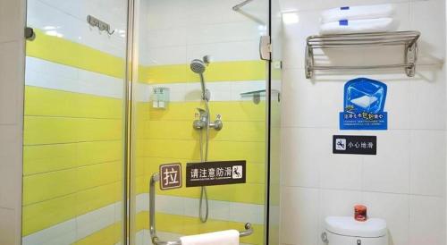 a bathroom with a shower with a glass door at 7 Days Inn Yiyang Shengli Road in Shangrao
