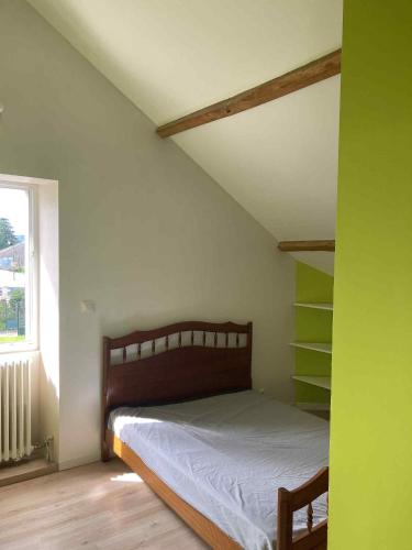 a small bedroom with a bed and a window at Maison du bonheur SPA in Neuvic