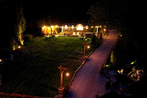 a view of a church at night with a cross at Friday Inn Igloo - Intimitate, Jacuzzi, Natura, Priveliste & Iaz - Escapadă romantică premium la o oră de Bucuresti - Eco Friendly Micro-Resort in Comarnic