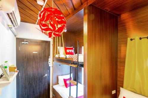 a room with a bunk bed with red pillows at OYO 895 The Onion Hostel in Bangkok