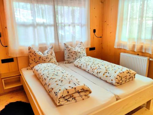 a bed with pillows on it in a bedroom at Gögelehof in Stulles