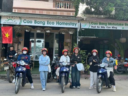 a group of people on motorcycles in front of a building at Cao Bang Eco Homestay in Cao Bằng